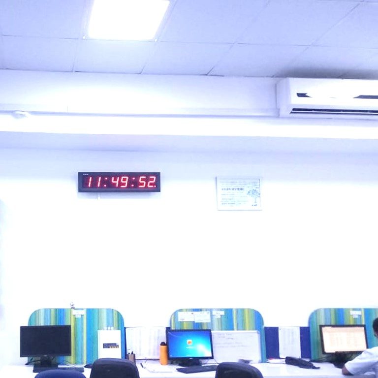 NTP Clocks by KritiKal - Network Time Protocol. This image shows an NTP Clock, which uses the Network Time Protocol, to be in sync; shown here in an office environment